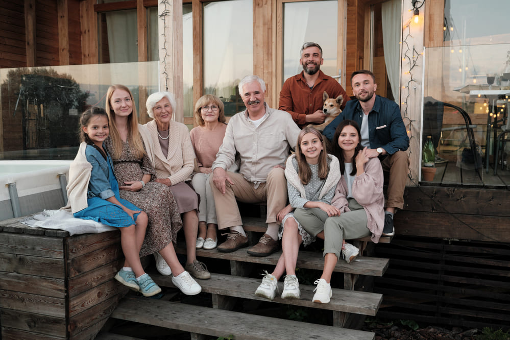 portrait-big-happy-family-sitting-porch-smiling-they-gathered-their-big-house-country